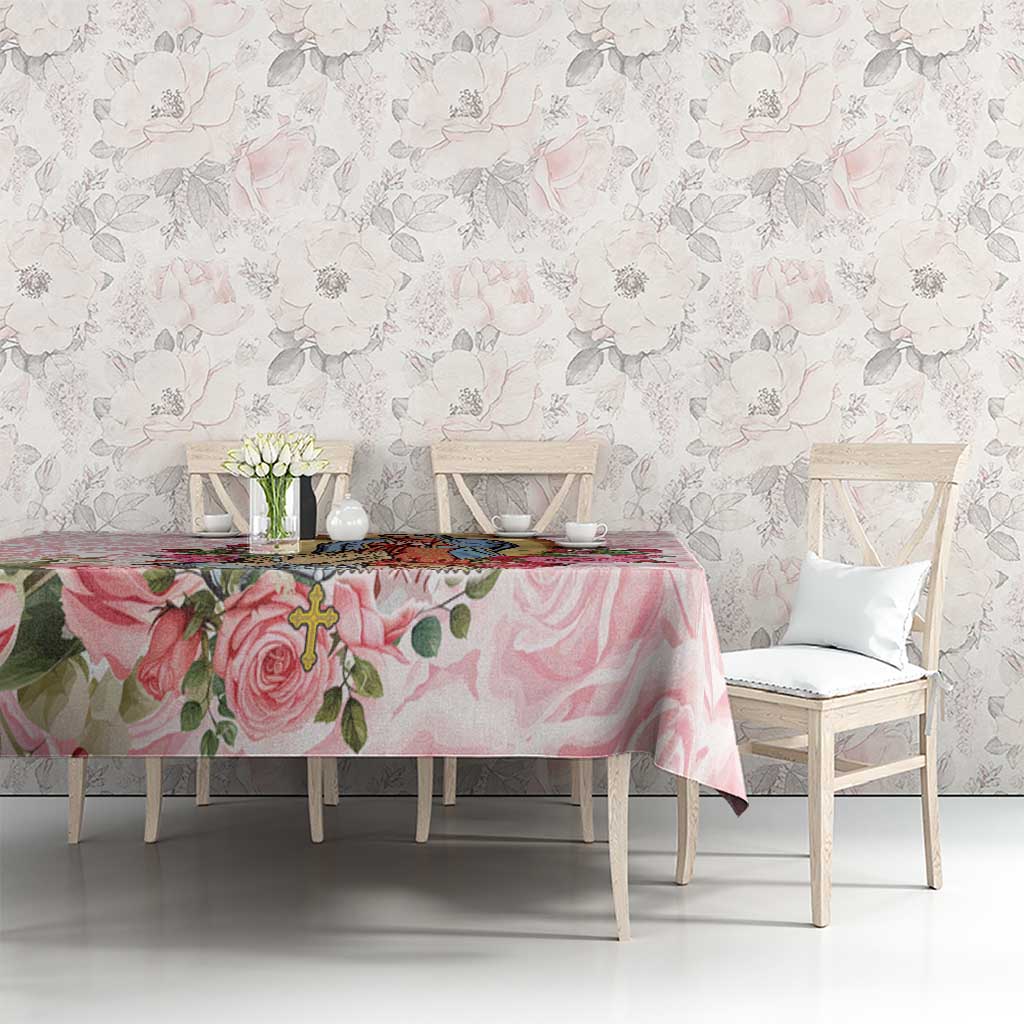 Pink rose tablecloth on a dining table, surrounded by chairs and pastel floral backdrop.