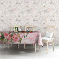 Pink rose tablecloth on a dining table, surrounded by chairs and pastel floral backdrop.