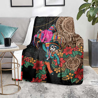 Black blanket on floor with colorful skeleton and floral pattern plus Aztec circular design