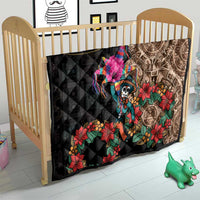 Black quilt blanket on baby bed with Aztec circle design, skull dancer, and flowers