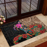Black rubber doormat with colorful piñata, skull, and floral Aztec circle design