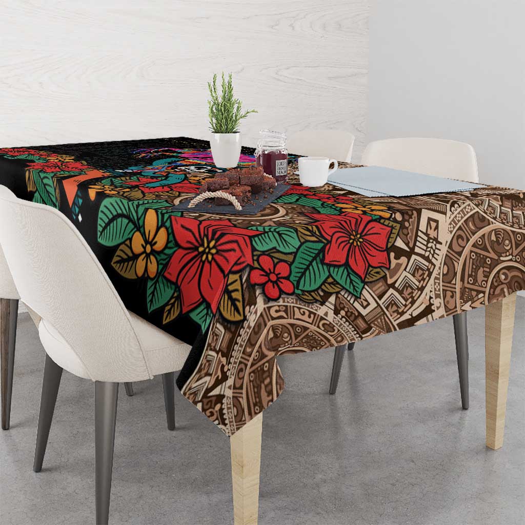 Black tablecloth draped on table edge with bold multicolor floral and Aztec pattern