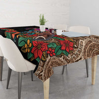 Black tablecloth draped on table edge with bold multicolor floral and Aztec pattern