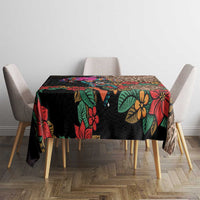 Black tablecloth with vibrant floral and Aztec geometric prints on dining table