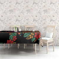Black tablecloth with multicolor floral and Aztec motifs on long dining table