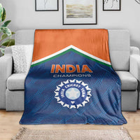 India cricket champions blanket on a couch, blue design with orange top and 'INDIA' crest