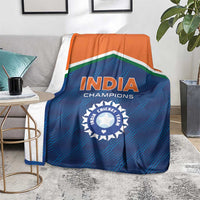 India cricket champions blanket on the floor, blue field with orange band and 'INDIA' crest