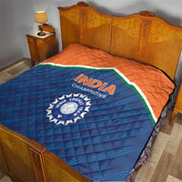 India Champions quilt covering a bed, orange and blue design with flag border and logo.