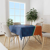 Blue India cricket tablecloth with orange and green border, draped over dining table