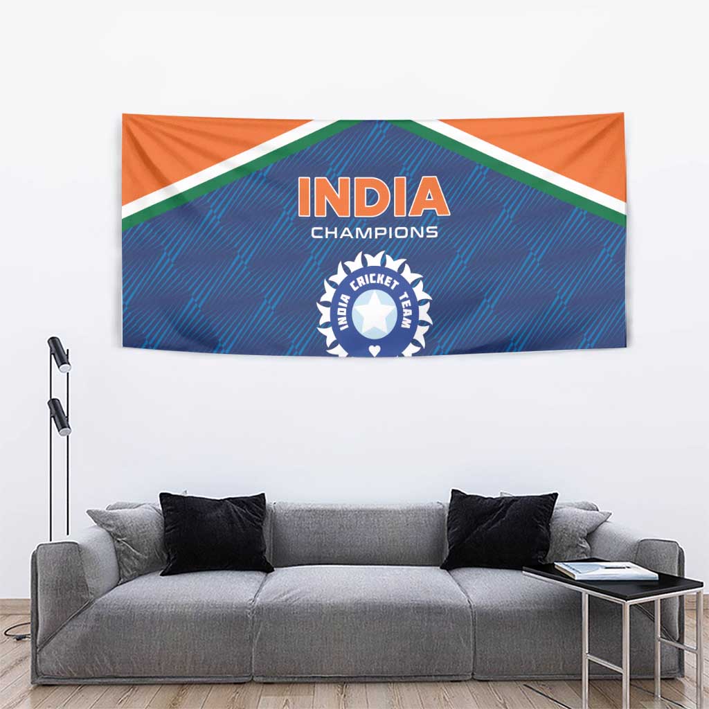 Cricket tapestry above gray sofa, India Champions crest centered on blue/orange design