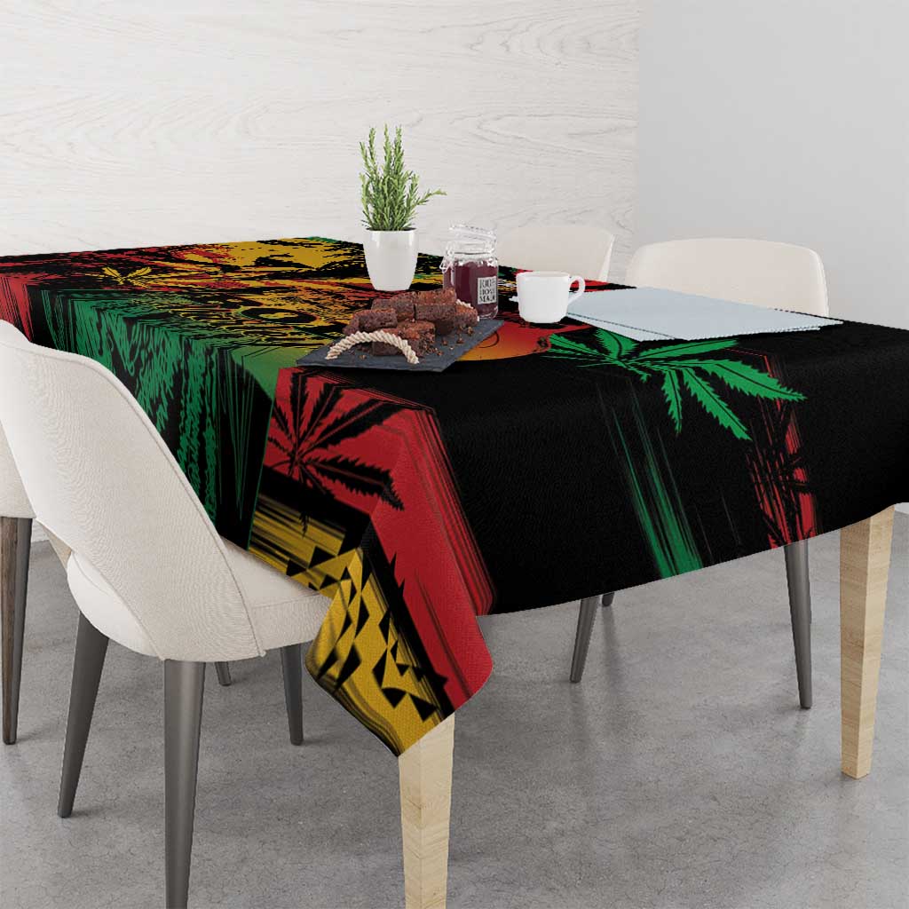 Black tablecloth with vivid green, red, and yellow reggae lion and leaf graphics across surface.