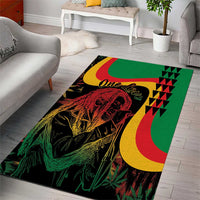 Rectangular green reggae area rug with 'One Love' text, portrait graphic, and geometric blocks