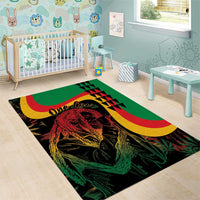 Green reggae area rug with 'One Love' text, stylized portrait, and red-yellow crescent design