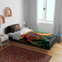 Reggae bedding set on bed: green duvet with lion artwork, red/yellow crescent stripe, 2 pillows