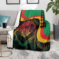 Reggae Marley throw blanket on a lounge chair, green background with One Love text