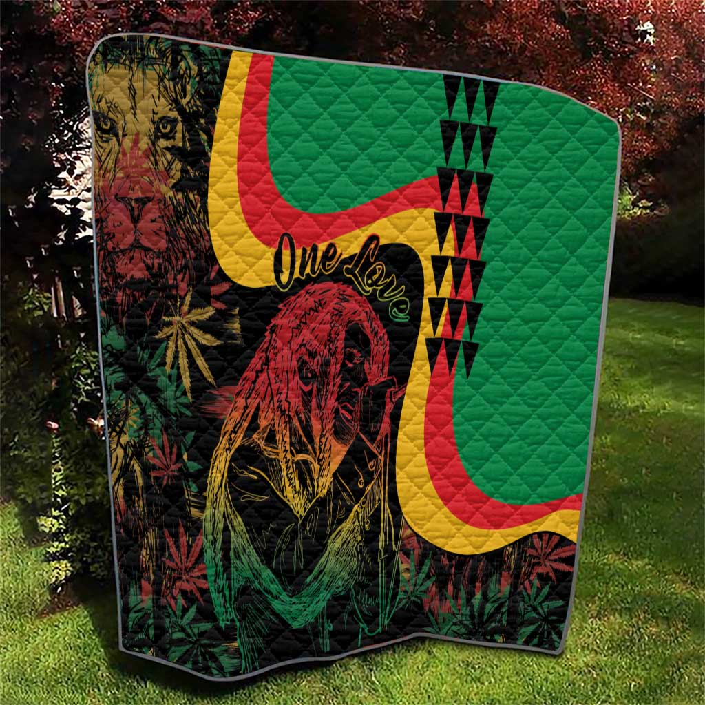 Green quilt blanket with lion artwork, maroon leaf accents, curved reggae stripes, 'One Love'