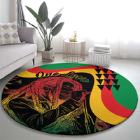 Round reggae-themed area rug featuring One Love text, red lion illustration, and green trim