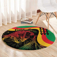 Round reggae-themed area rug with black lion artwork, One Love script, and geometric accents