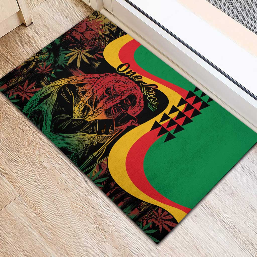 Green rubber doormat with Marley portrait, One Love script, yellow-red arcs and triangle pattern