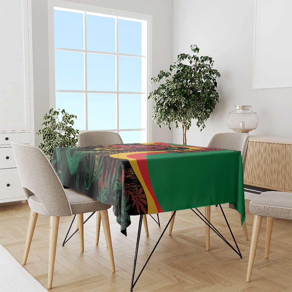 Green tablecloth with bold multicolor reggae graphics draped over dining table
