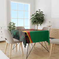 Green tablecloth with bold multicolor reggae graphics draped over dining table