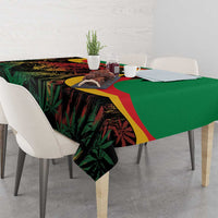 Green tablecloth with multicolor reggae print draped across table corner
