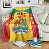 Grenada flag style fleece blanket with Gwenad 1974 crest and stars, draped on sofa