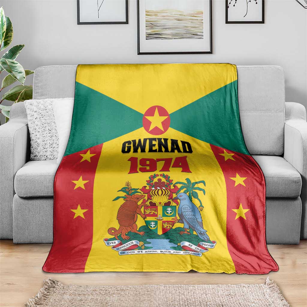 Grenada flag style fleece blanket with Gwenad 1974 crest and stars, laid over gray couch