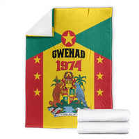 Grenada flag style fleece blanket with Gwenad 1974 crest and stars, folded with rolled towels
