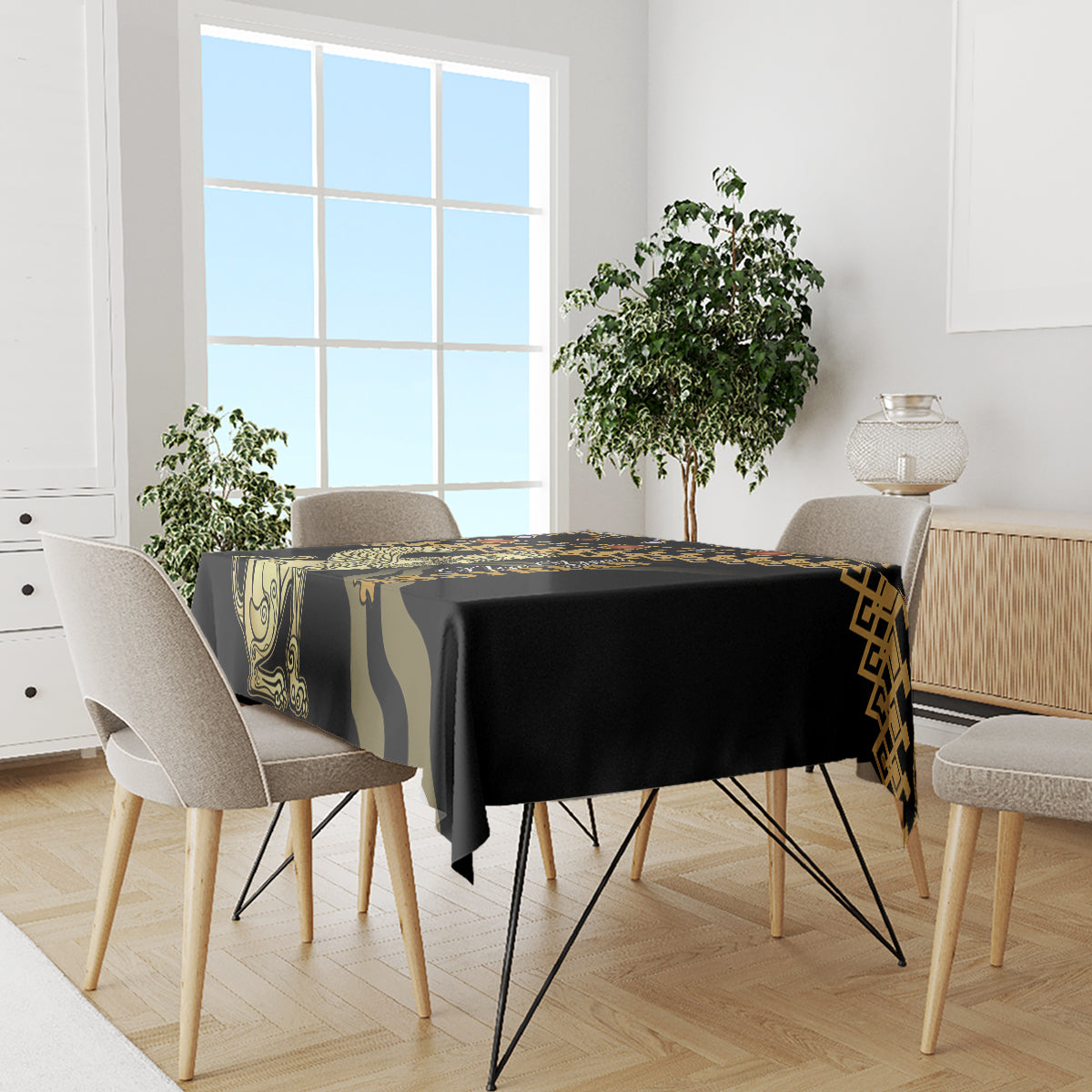 Black tablecloth with gold geometric trim and green ornamental bands on dining table