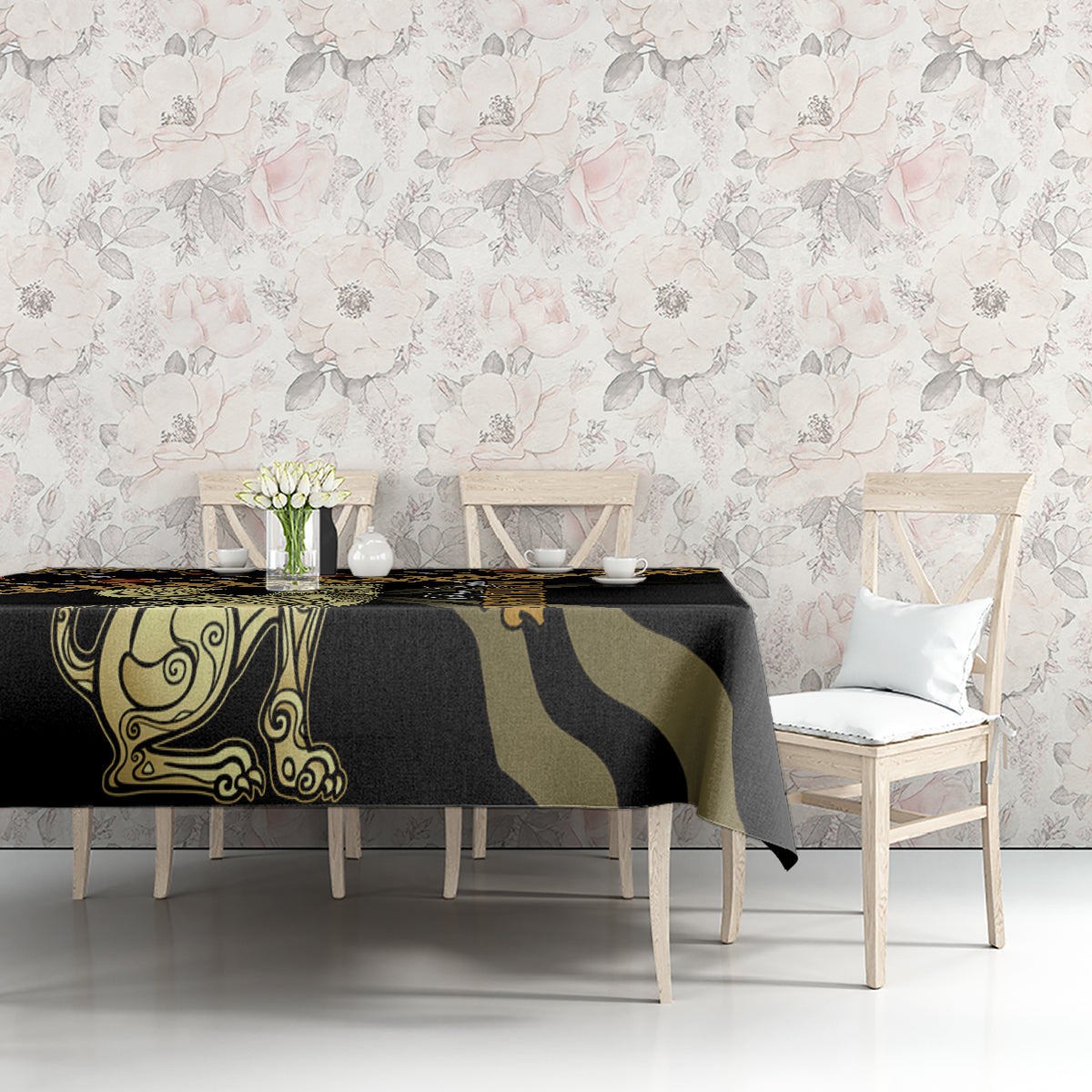 Black tablecloth with gold and green ornate motifs, laid on a sofa-style console table