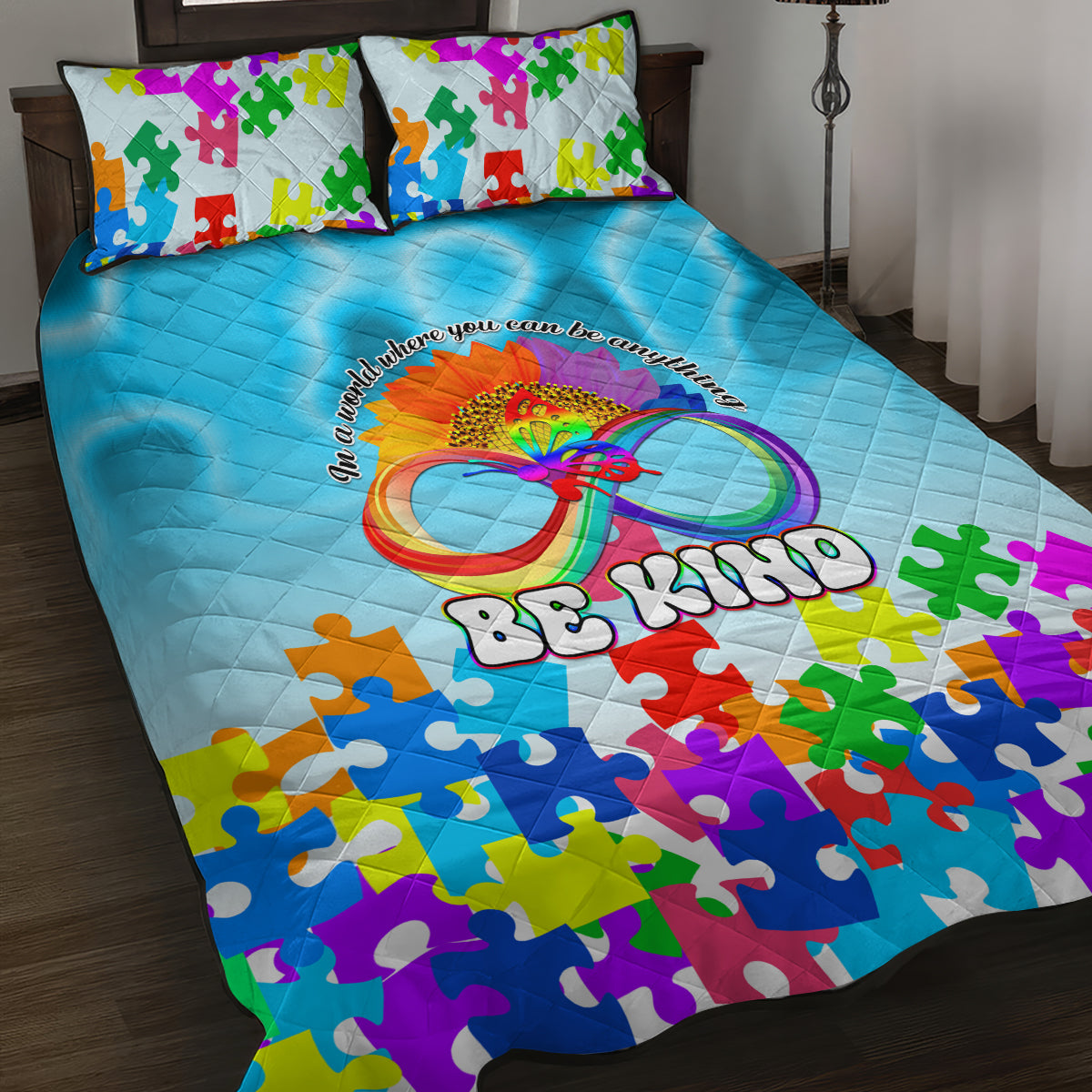 Blue quilt bed set with rainbow butterfly and colorful puzzle-piece pattern, plus two pillows