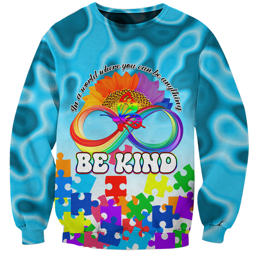 Unisex blue sweatshirt with colorful butterfly jigsaw graphic and 'BE KIND' text