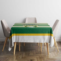 Green and yellow striped rugby tablecloth on round dining table with four chairs