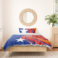 Blue and red Chile bedding set with white stars and logo, draped on wooden bed frame.