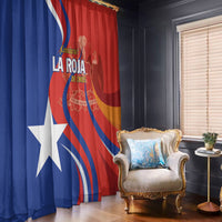 Red and blue Chile football window curtains with flag graphics, hanging by an armchair