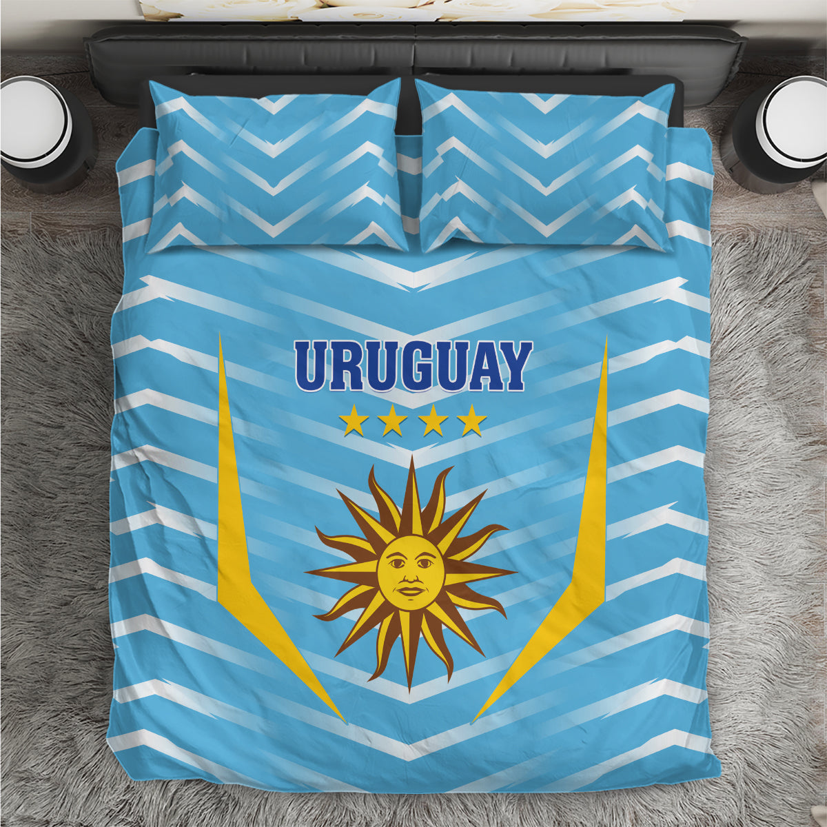 Blue Uruguay bedding set viewed from above with chevron stripes, sun crest, and stars