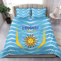 Blue Uruguay bedding set with chevron pattern, sun emblem, and “URUGUAY” on duvet