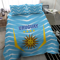 Blue Uruguay bedding set featuring chevron stripes, sun crest, and “URUGUAY” text