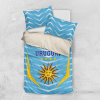 Blue Uruguay bedding set flat lay with sun crest, stars, and “URUGUAY” on duvet