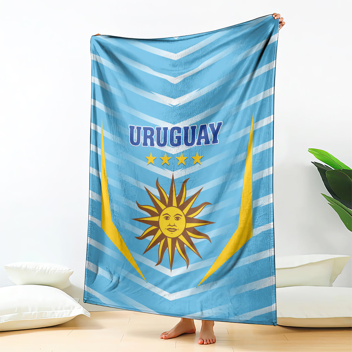 Uruguay football blanket hanging over bed, light blue chevrons with sun emblem and stars