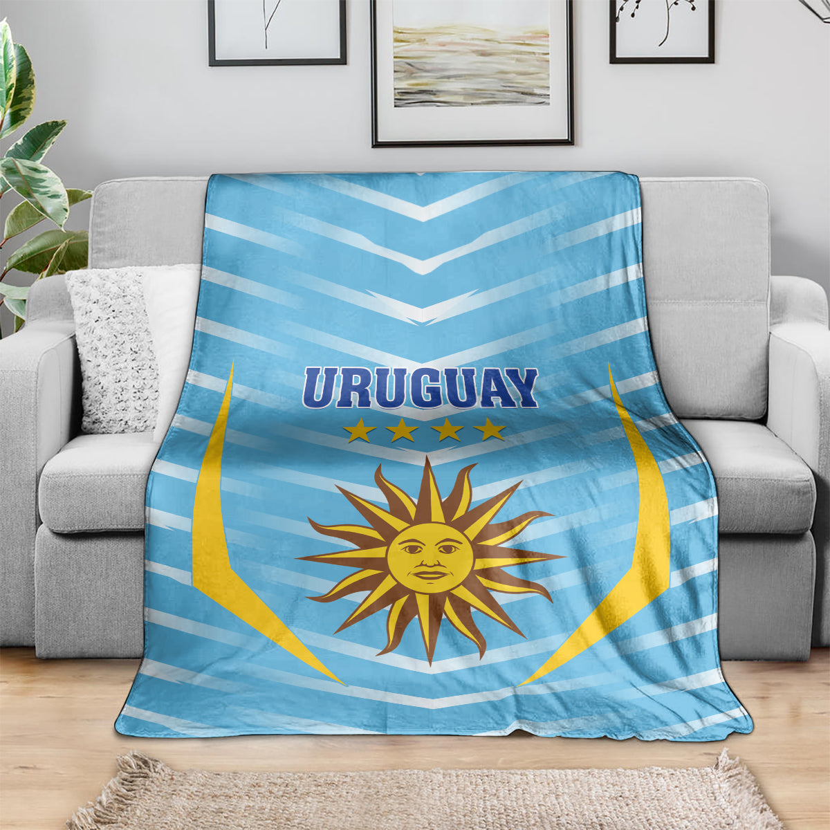Uruguay football blanket draped on sofa, light blue chevrons with sun emblem and stars