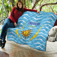 Light blue Uruguay football quilt draped on outdoor seating, 'URUGUAY' and sun emblem