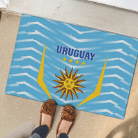 Blue rubber doormat underfoot with Uruguay sun emblem and lightning frame