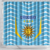 Blue shower curtain with Uruguay wordmark and flag-style shield and sun design