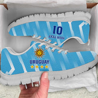 Light blue Uruguay football sneakers with crest, white sole and light laces