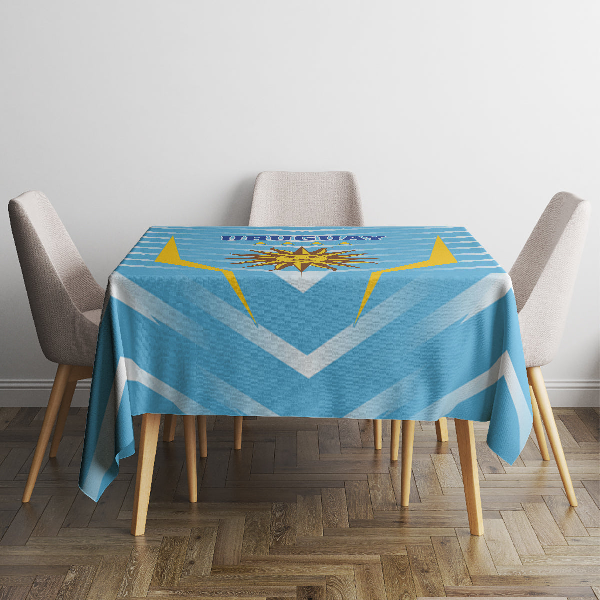 Uruguay-themed football tablecloth draped on dining table, blue chevrons with gold star emblem.