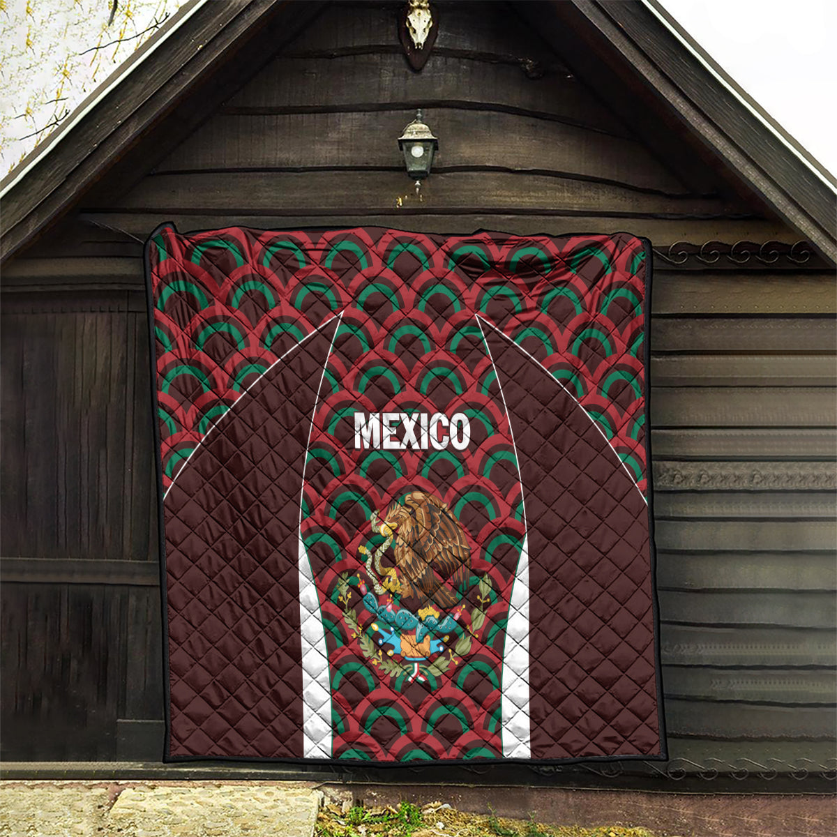 Mexico football quilt hanging in doorway, dark brown with green/red fan pattern and central crest