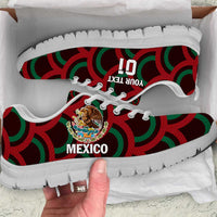 Red, green, and black low-top sneakers with Mexico emblem, lace-up, white sole