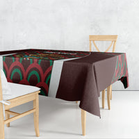 Maroon tablecloth draped over rectangular table, colorful Mexico emblem and waves visible